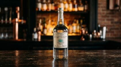 Casamigos Blanco tequila bottle on a dark bar.