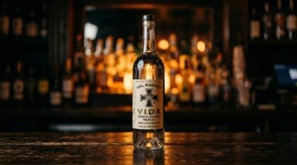 Del Maguey Vida mezcal bottle on a dark bar.