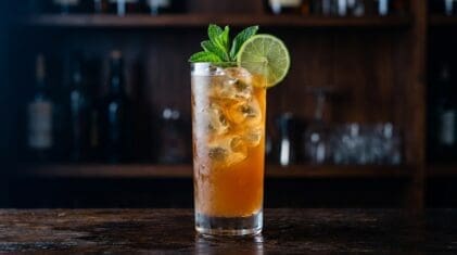Aggie Punch cocktail in tall highball glass with ice
