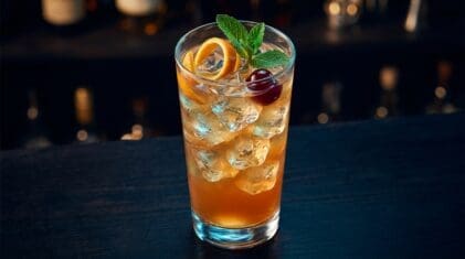 Apricot Punch cocktail in tall highball glass with ice