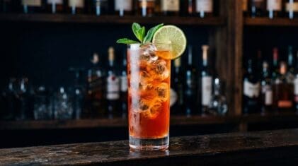 Bayou Punch cocktail in tall highball glass with ice