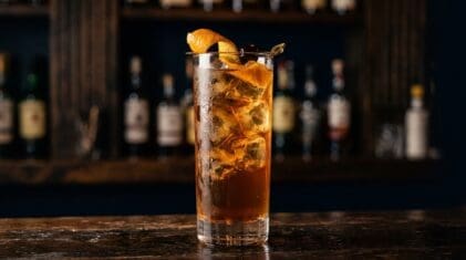 Fruit And Sherbet Punch cocktail in tall highball glass with ice