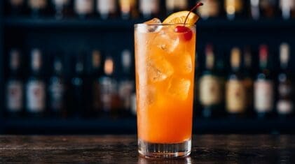 Spring Cooler Punch cocktail in tall highball glass with ice