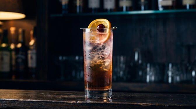 Trashcan Punch cocktail in tall highball glass with ice