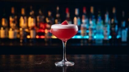 French Martini with pink-red cocktail and a single raspberry.