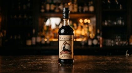 Goslings Black Seal Bermuda rum bottle on a dark bar.