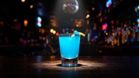 Jelly Belly shot in a shot glass with bright blue colour from vodka, blue curacao and lemonade