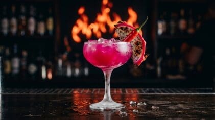 Tropical dragon fruit rum cocktail with chili and dragon fruit garnish