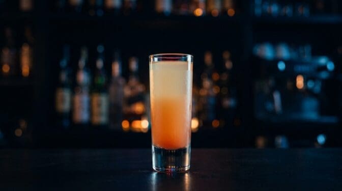 Nude Beach shot with peach, coconut, orange, cream layers.