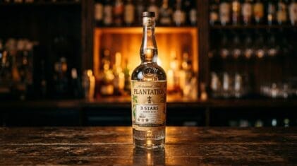 Plantation 3 Stars white rum bottle on a dark bar.