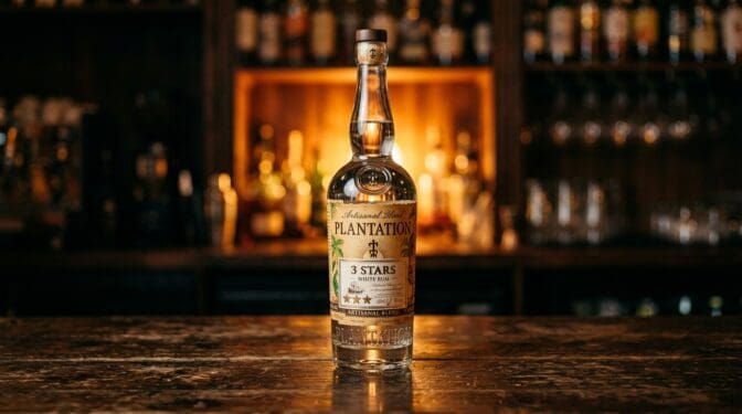 Plantation 3 Stars white rum bottle on a dark bar.