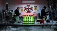 White pharmaceutical lab with rack of glowing green test-tube cocktails and Umbrella logo