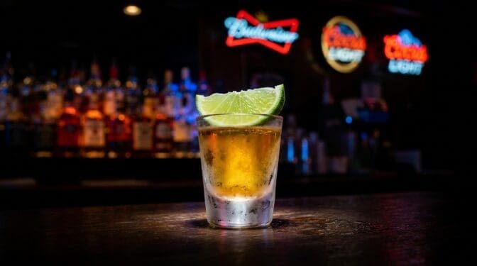 SoCo and Lime shot of Southern Comfort with a fresh lime wedge garnish in a shot glass